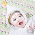 Cute funny laughing baby girl on colorful blanket Royalty Free Stock Photo