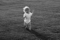 Cute funny laughing baby learning to crawl, having fun playing on the lawn watching summer in the garden. Happy Royalty Free Stock Photo