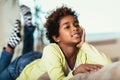 Funny little african american girl looking at camera, smiling mixed race child posing for portrait at home Royalty Free Stock Photo