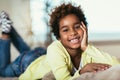 Little african american girl looking at camera, smiling mixed race child posing for portrait at home