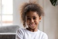 Cute funny little african american girl looking at camera