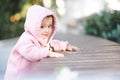 Cute funny little baby girl 1-2 year old wear sweatshirt with hood posing outdoors in park. Royalty Free Stock Photo