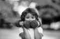 Cute funny little boy doing exercises with dumbbells in green park. Closeup portrait of sporty child with dumbbells Royalty Free Stock Photo