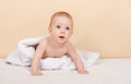 Cute and funny little boy smiling under blanket or towel. Newborn baby Royalty Free Stock Photo
