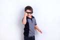 Cute funny little boy wearing sunglasses, studio shoot on white. Royalty Free Stock Photo