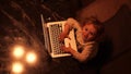 Overhead view of a cute funny little girl pretending to work on the laptop Royalty Free Stock Photo