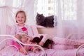 Cute funny little girls (sisters) play in bed, on the window sit Royalty Free Stock Photo