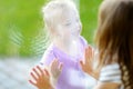 Cute funny little sisters playnig by a window Royalty Free Stock Photo