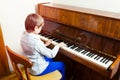 Cute funny llittle child playing piano Royalty Free Stock Photo