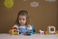 Cute funny preschooler little girl playing with construction toy blocks building a tower in kindergarten room. Royalty Free Stock Photo