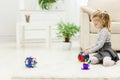 Cute funny preschooler little girl playing with construction toy blocks building a tower in a sunny room. Royalty Free Stock Photo