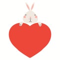 Cute funny rabbit holding a big heart, isolated