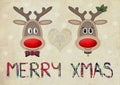 Cute funny reindeer in love on old paper background with text merry christmas