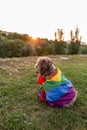 Cute funny spanish brown water dog with a colorful rainbow gay flag. Pride festivity concept. lifestyle outdoors