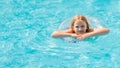 Cute funny teen girl in a swimsuit with an inflatable lifebuoy swims in the pool Royalty Free Stock Photo