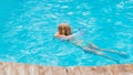 Cute funny teen girl in a swimsuit with an inflatable lifebuoy swims in the pool Royalty Free Stock Photo