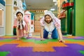 Cute funny woman and man like baby crawling on floor