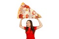 Cute funny young girl holds over herself huge piece of pizza with cheese, isolated on a white background Royalty Free Stock Photo