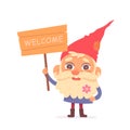 Cute garden gnome standing with welcome wooden sign, old cheerful dwarf from fairy tales Royalty Free Stock Photo