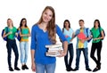 Cute german female student with books and group of students Royalty Free Stock Photo