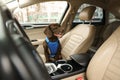 Cute German Shorthaired Pointer dog waiting for owner on front seat of car. Adorable pet Royalty Free Stock Photo