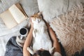 Hygge concept with cat, book and coffee in the bed