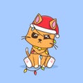 Cute ginger cat tangled in christmas lamp