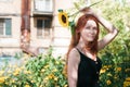 Cute ginger girl posing with sunflower outdoor Royalty Free Stock Photo