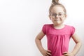 Cute ginger good looking little girl standing with hands on hips.