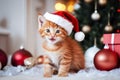 Cute ginger kitten in red Santa hat sitting among Christmas decor with garland lights bokeh festive background. Royalty Free Stock Photo