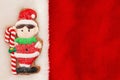 Cute gingerbread elf on red plush material holiday background