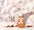 Cute Gingerbread Snowman Cookie in front of Hot cocoa with Marshmallows