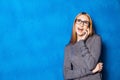 Cute girl against blue wall Royalty Free Stock Photo