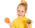 Cute girl with an apple and kiwi in his hand Royalty Free Stock Photo