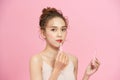 Cute girl applying lip gloss Royalty Free Stock Photo