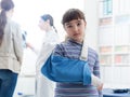 Cute girl with arm brace in the doctor`s office