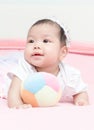 Cute girl baby play ball on pink blanket Royalty Free Stock Photo