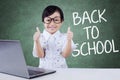 Cute girl back to school and shows thumb up Royalty Free Stock Photo