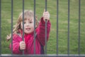 Cute girl behind bars Royalty Free Stock Photo