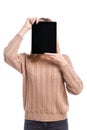 Girl covers her face with a tablet on a white background