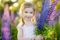 Cute girl in blooming lupine field
