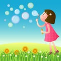 Cute girl blowing bubbles on the lawn