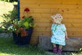 Cute girl in blue dress sitting in front children playhouse Royalty Free Stock Photo