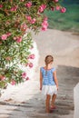 Cute girl in blue dresses having fun outdoors on Mykonos streets Royalty Free Stock Photo