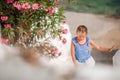 Cute girl in blue dresses having fun outdoors on Mykonos streets Royalty Free Stock Photo