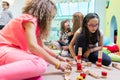 Cute girl building a structure in balance during playtime at the Royalty Free Stock Photo