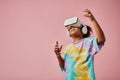 Cute girl in casualwear and VR headset standing in front of camera Royalty Free Stock Photo