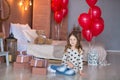 Cute girl celebrating birth day together close to red balloons.Lovely scene of girl in blue dress. Royalty Free Stock Photo