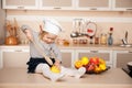 Cute girl with chef hat holding big wooden spoon Royalty Free Stock Photo