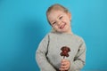 Cute girl child eating sweet chocolate candy on blue background. Happy childhood Royalty Free Stock Photo